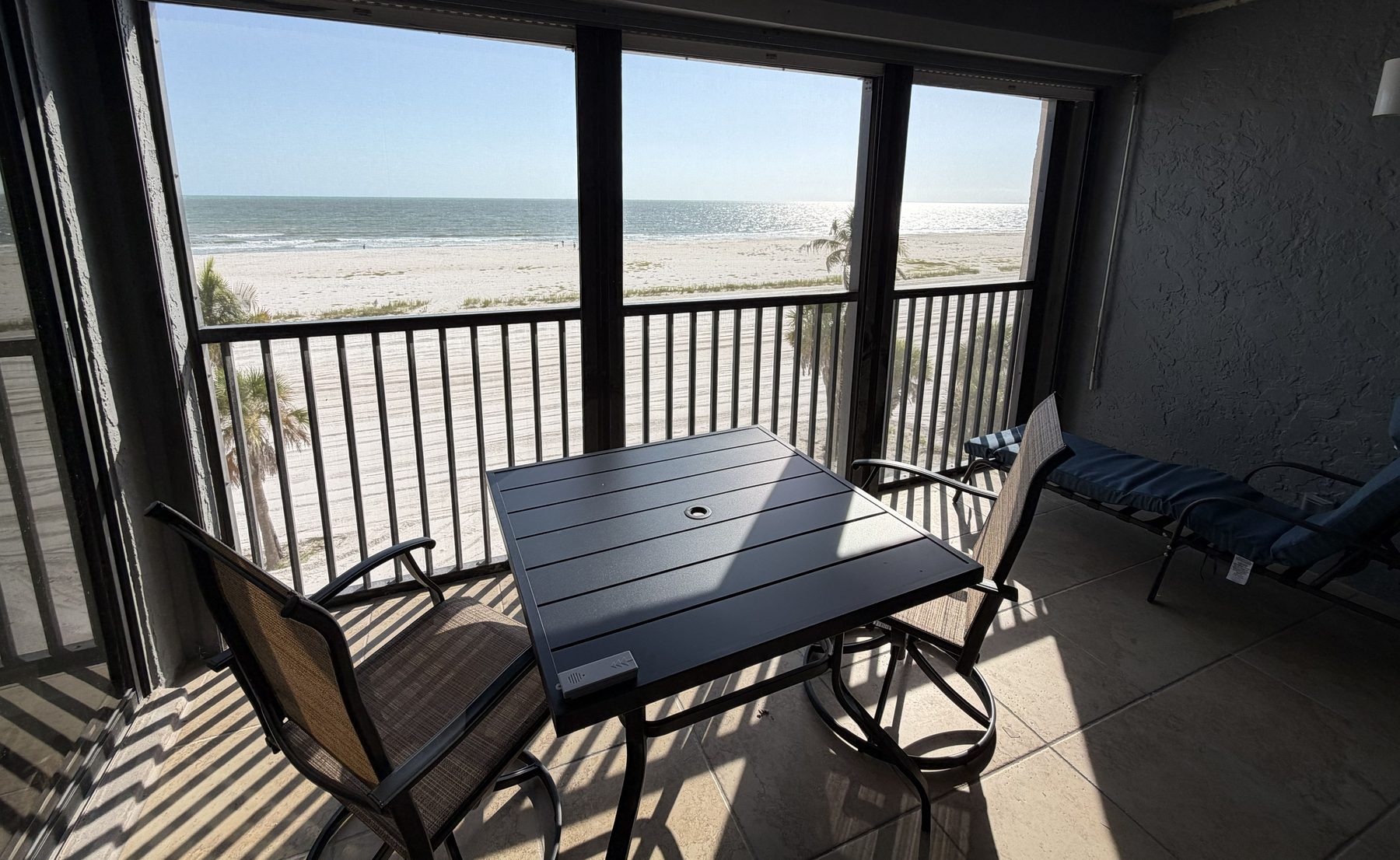 View from the screened lanai over the white sand to the Gulf of Mexico