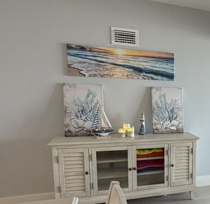 Coastal console with beach towels stocked for guests