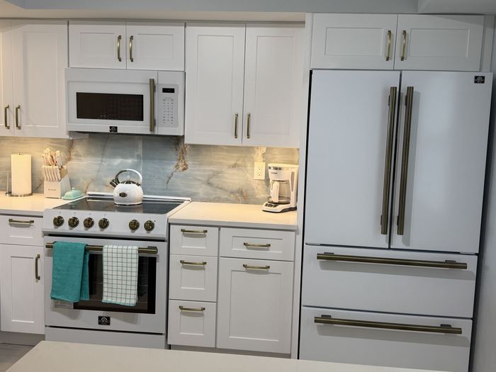 Kitchen with white and gold Forno refrigerator, range and microwave