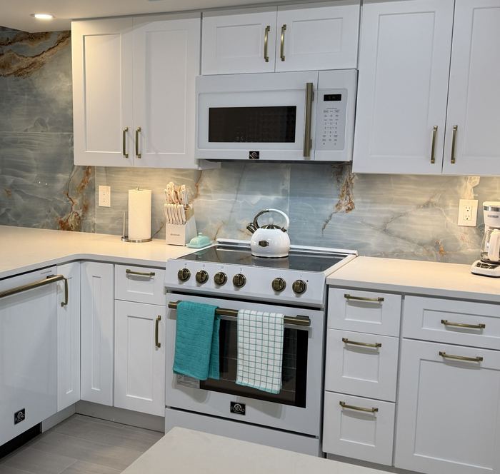 Range and full height agate slab backsplash with under cabinet lighting