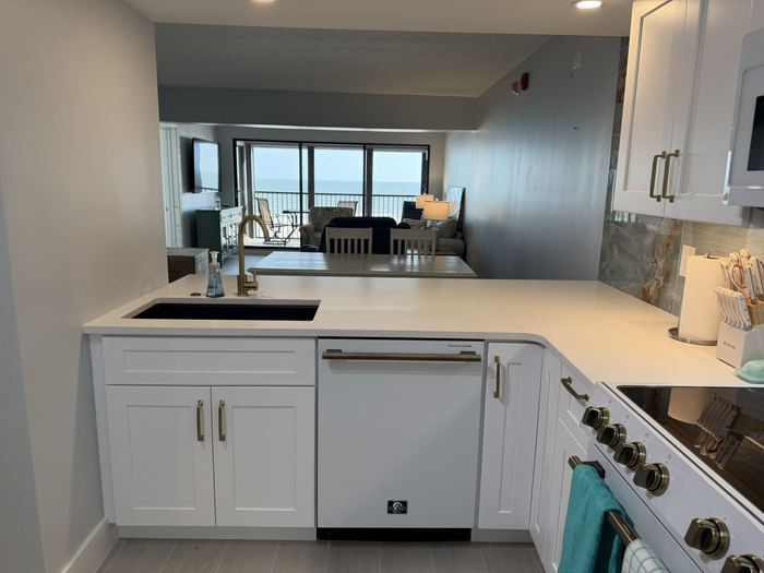 Kitchen sink and breakfast bar looking through to the living room and Gulf