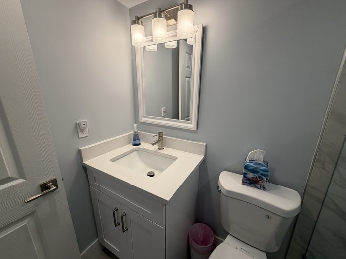 Guest bath vanity with quartz top and framed mirror